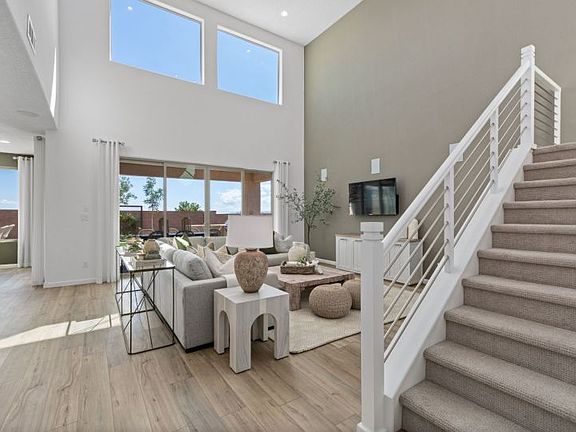 Modern railing adorns the staircase leading upstairs.