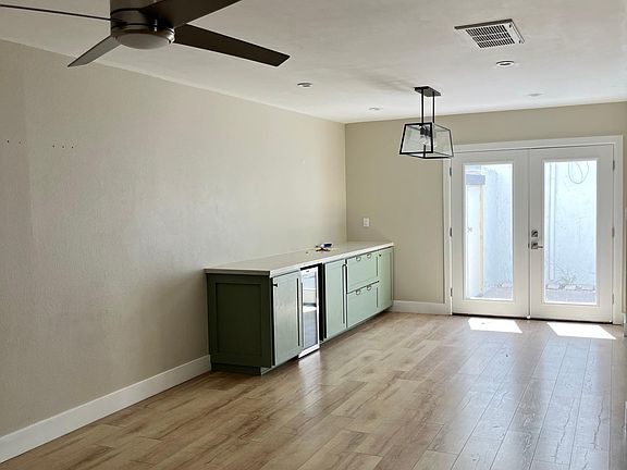 Dining area - French doors to patio. Custom built in buffet, quartz countertop, wine fridge.