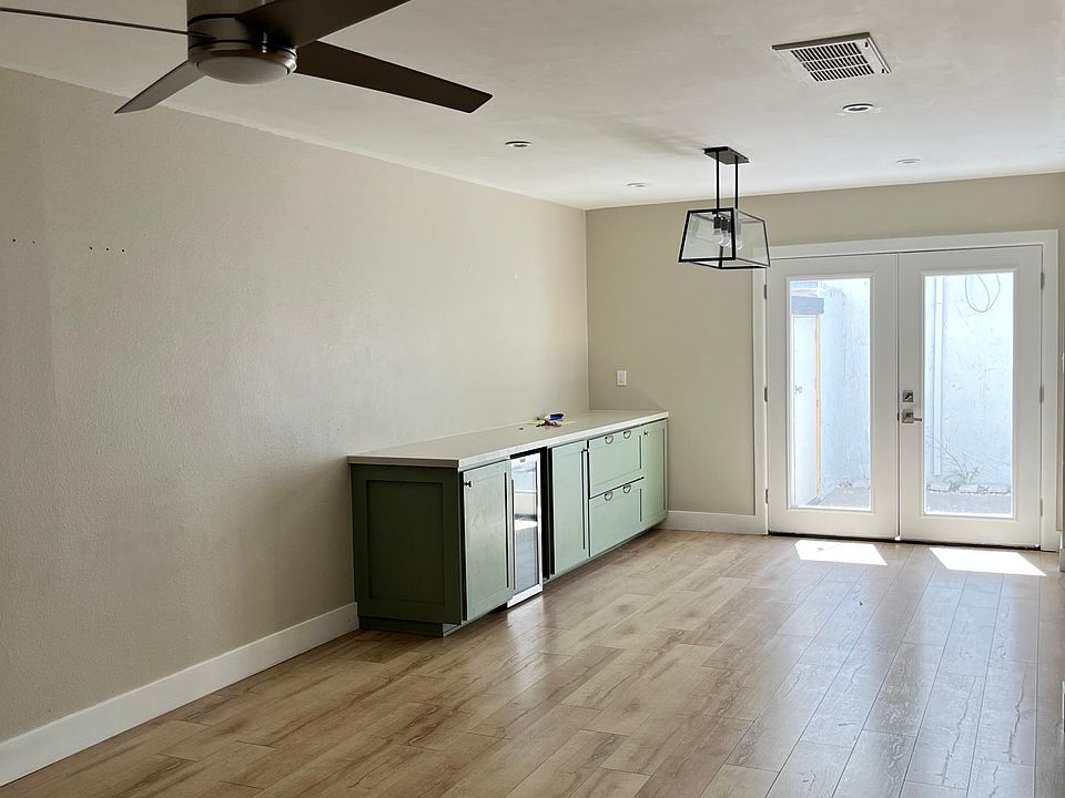 Dining area - French doors to patio. Custom built in buffet, quartz countertop, wine fridge.