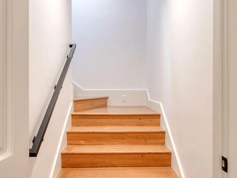 Wide, wooden stairs to private Master Bedroom