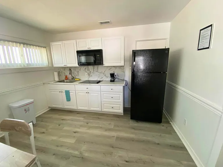 Fully equipped kitchen with coffee maker, microwave & refrigerator.