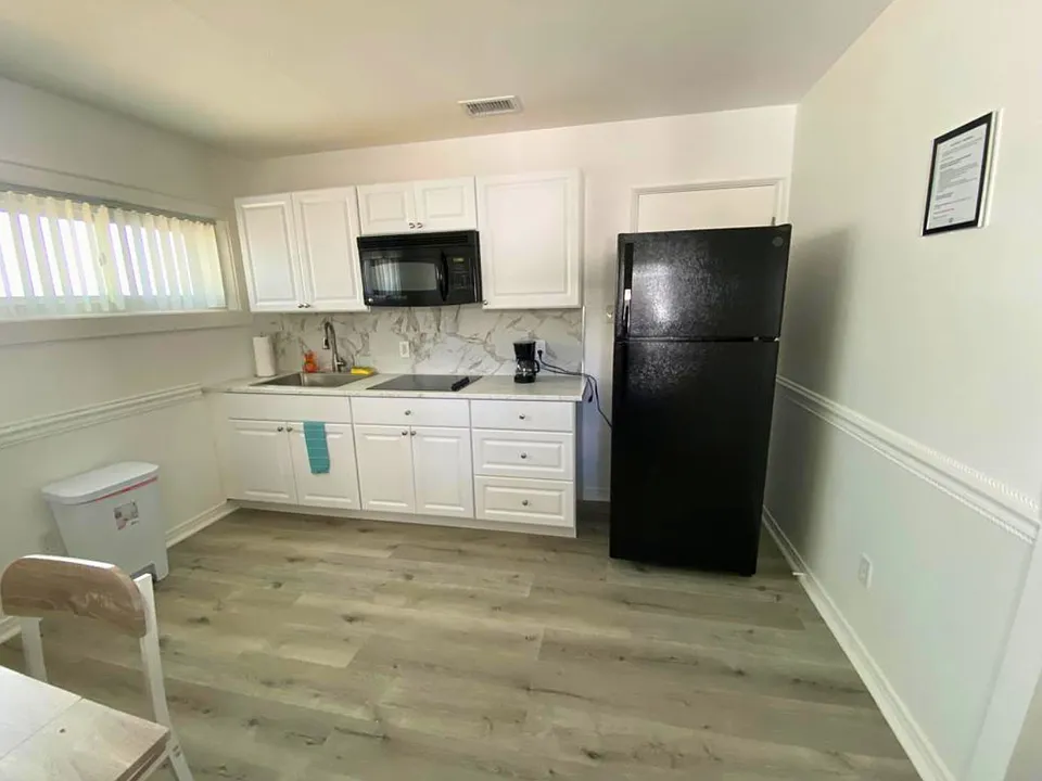Fully equipped kitchen with coffee maker, microwave & refrigerator.