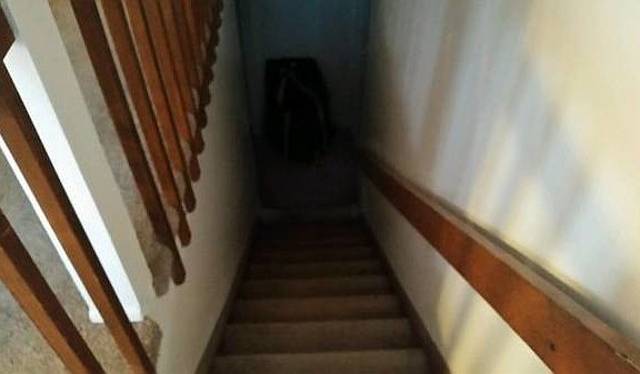 stairs going down to unfinished basement