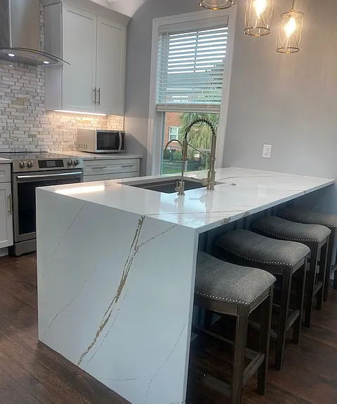 Large granite counter wirh sink and eating area.
