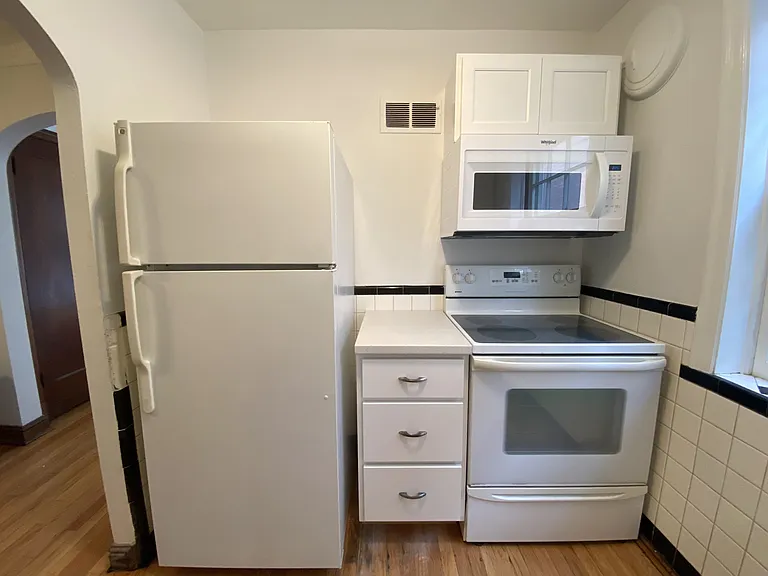 Over the range microwave, electric range, and refrigerator.