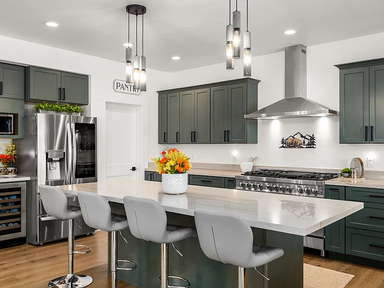 Beautiful chef's kitchen featuring a large island, walk-in pantry, microwave, coffee station, and beverage refrigerator for wine or sodas.