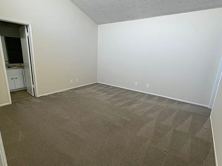 Bedroom with vaulted ceiling