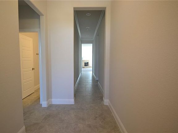 Large format upgraded tile throughout entry, halls, and all wet areas!  5 inch baseboards.