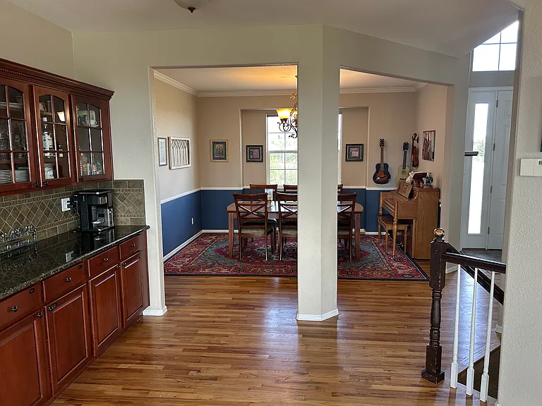 Dining Room (by entry and vaulted ceilings to right)