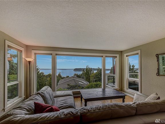 West facing view to Whidbey Island and Olympic Mountains from huge picture window in living room.