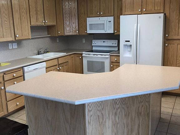 Large island and room for dining table where the photographer is standing.