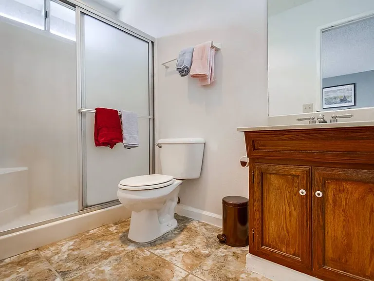 Step into comfort with a spacious walk-in shower for a refreshing experience.
