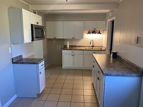 Beautifully remodeled kitchen with new cabinets, new countertops, new sink and faucet as well as a new stainless microwave.