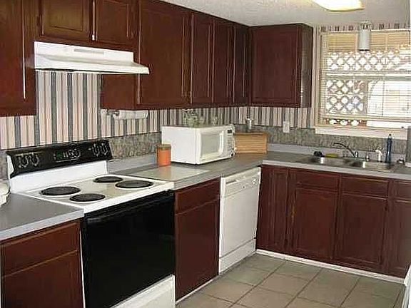 Open kitchen with window over the sink too!  Tile floor. Appliances convey.