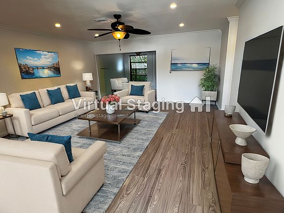 Living room with dining room to the back. Laundry room is also to the back right.