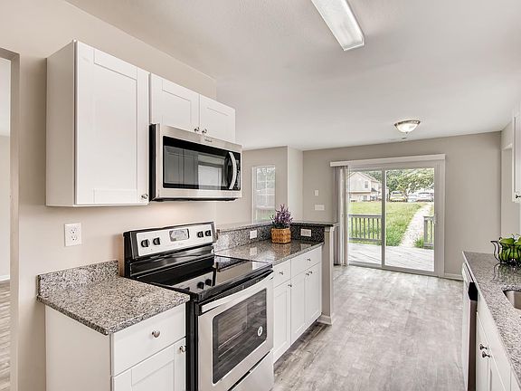 Stainless appliances and granite counters in kitchen