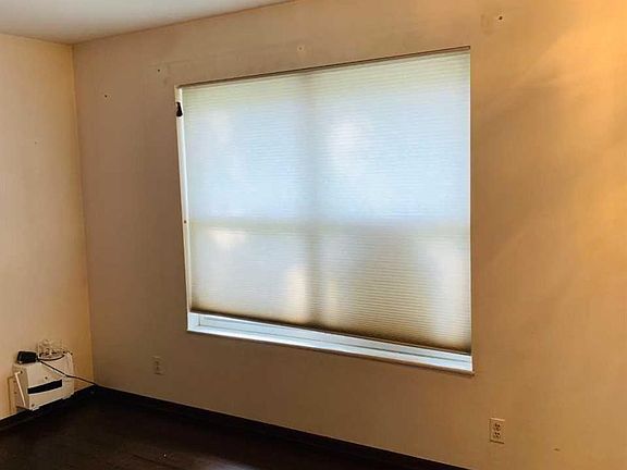 Large living room window overlooks the common garden in front of townhouse