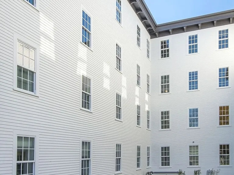 White Exterior Of Building With Garden