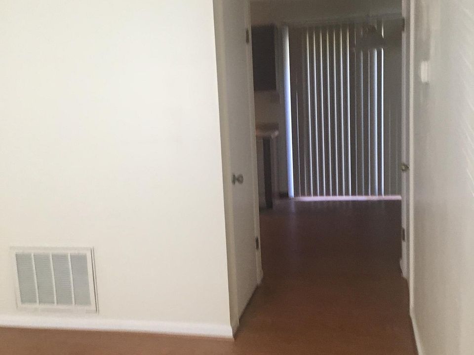 Hallway from living room to the half bath, kitchen and dining area.