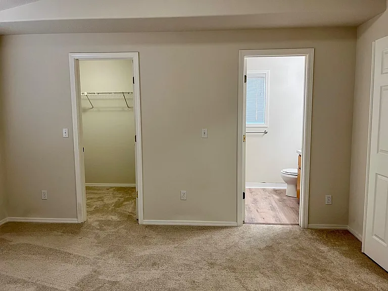 master bedroom suite with bathroom and walk in closet