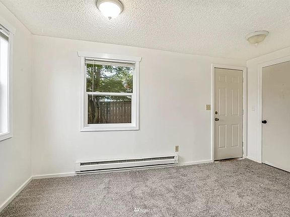Dining room or extra room with laundry closet, large storage closet and door to secure back yard.