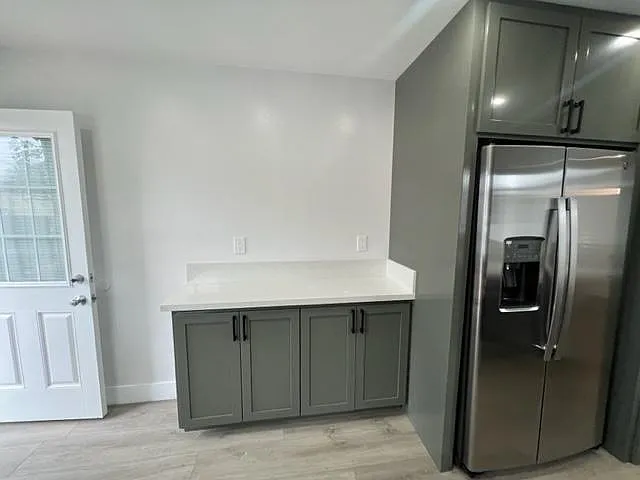 More storage cabinets in the kitchen as well as back door for additional ventilation. (Comes with security gate)