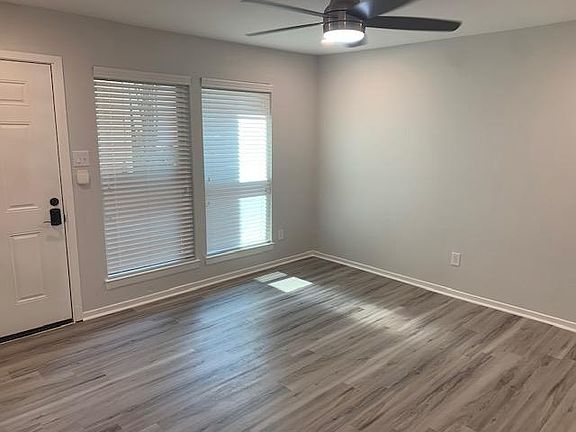 Family room, new recessed dimmable LED lighting plus new LED fan. All new flooring. New blinds in whole condo.
