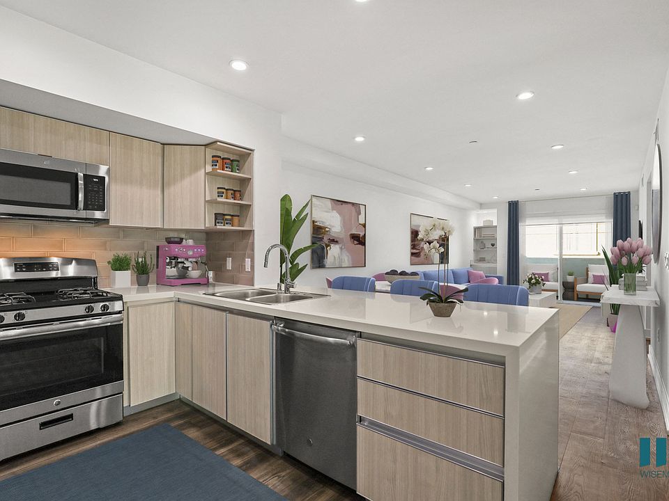 Open-Concept Kitchen with Stainless-Steel Appliances and Countertop Bar