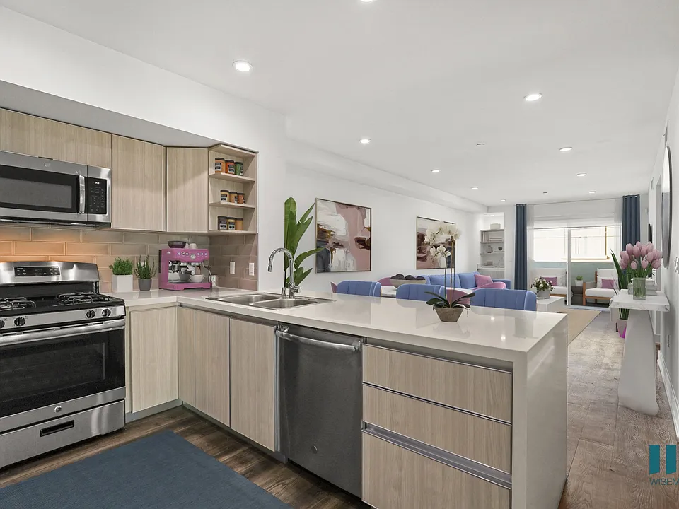 Open-Concept Kitchen with Stainless-Steel Appliances and Countertop Bar