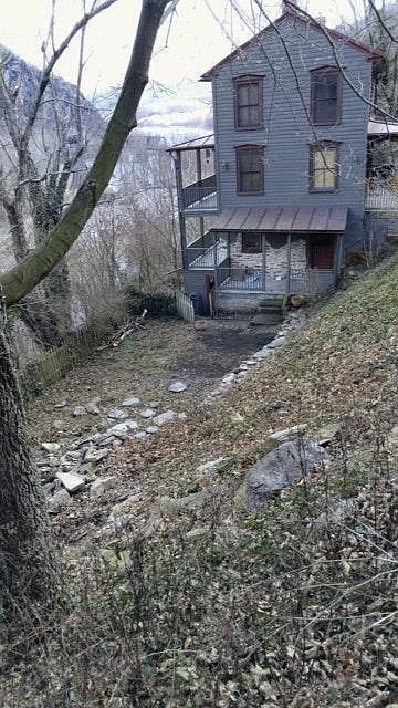 side yard and view of basement apt entrance