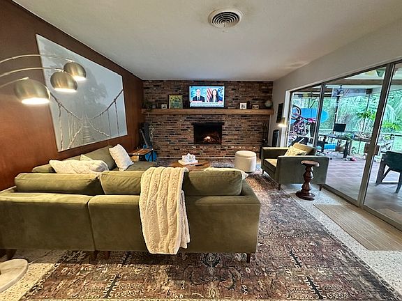 Living area with wood burning fireplace.