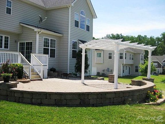 Spectacular paved outdoor living space with pergola.