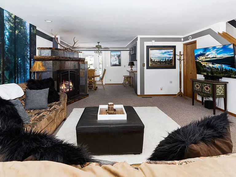 Downstairs main living room with fire, large Smart TV and movie theatre lounge vibe.