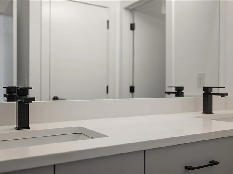 Main Bathroom (Note: Actual unit has light wooden floors and upgraded fixtures / appliances)