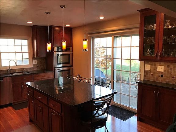 Glass display cabinet on right next to sliding glass door to patio areas.