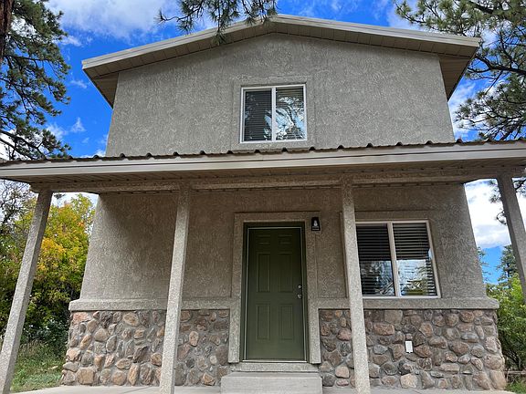 Front of house stucco and rock with a covered porch