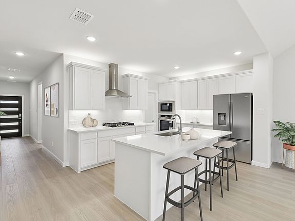 Kitchen in the Masters home plan by Trophy Signature Homes - REPRESENTATIVE PHOTO