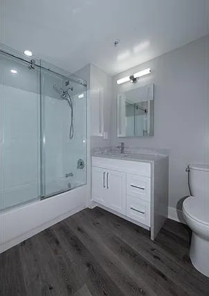 Hotel Luxury Bath: Barn-Style Glass Shower Doors, Quartz Waterfall Vanity, Shaker Wood Cabinet with Nickel Finish Hardware, Glamour Mirror/Lighting and Hi-Hats