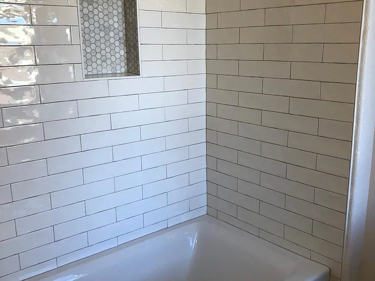 Freshly remodeled bathroom with new tiles and new extra deep soaking tub / shower.