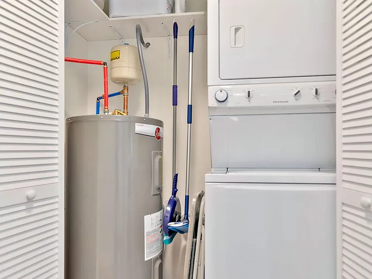 Utility closet with stacked washer/dryer