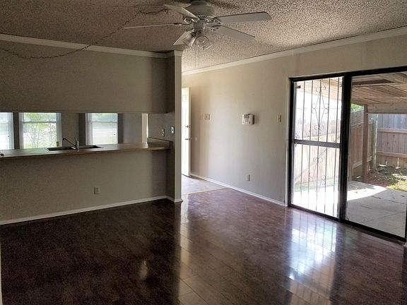 Kitchen pass through and patio doors to shaded patio