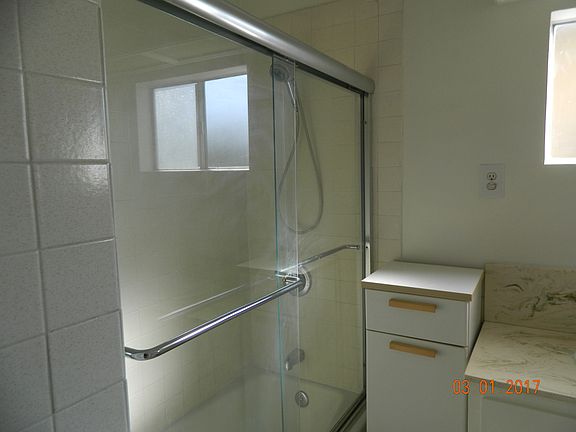 Bathroom with glass shower doors not plastic and lots of storage
