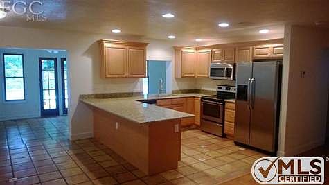 Super big breakfast bar will be a great family gathering place!  Stainless steel appliances bring modern look to this vintage home.