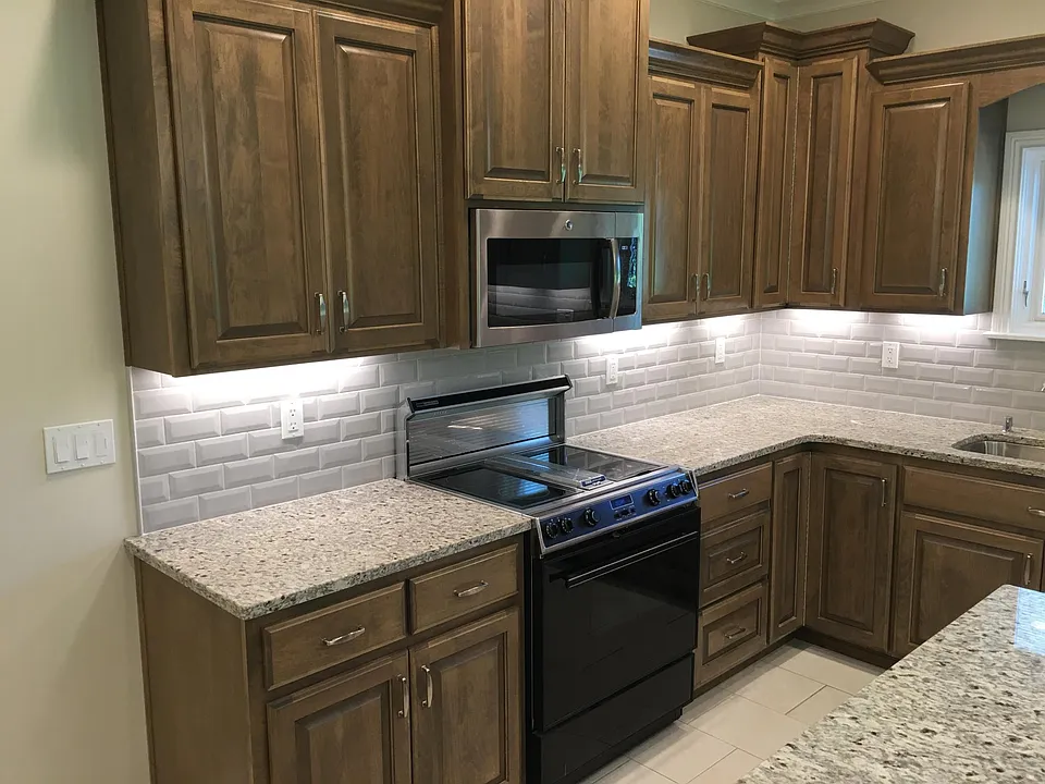 Kitchen with garbage disposal, dishwasher, stove, microwave, and refrigerator furnished.