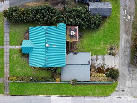 Large level lot provides entertaining space and offers alley access to 2 car carport>