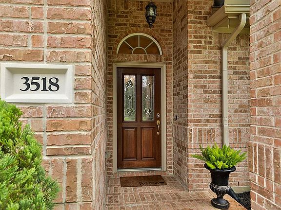 Enter under covered entry and wood door