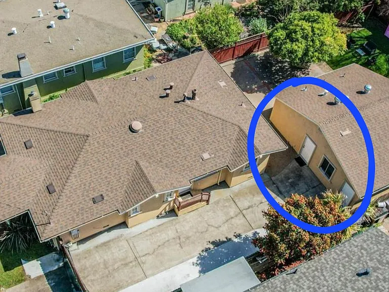 The unit is located behind the main house (circled in the photo)