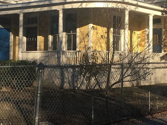Front from southeast view with peach tree in foreground 