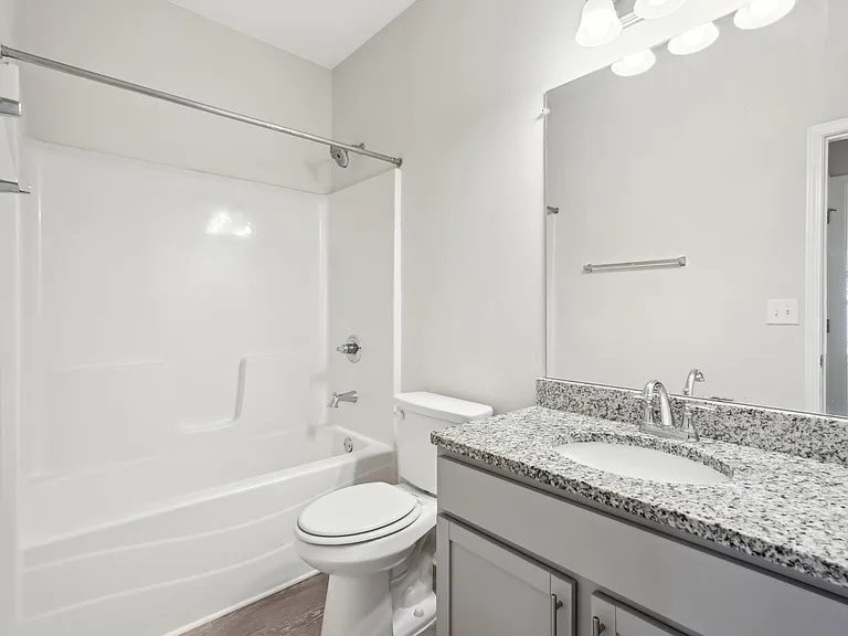Secondary bathroom with tub shower and single vanity.