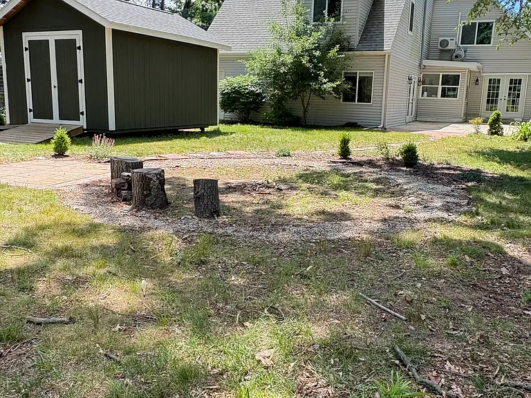 Adjacent to the designated circular fire pit area (fire pit not included), the patio serves as an ideal entertaining space; perfect for grilling, hosting a s'mores bar, or creating additional seating for family and friends.